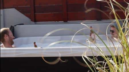 Video preview of guests relaxing and holding drinks in the private outdoor hot tub at Surf Atlantic.