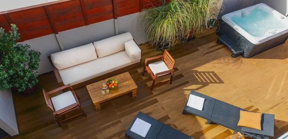 Baleal Holiday House Deck Patio Gallery High angle view of the outdoor patio deck featuring comfortable seating, coffee table, and hot tub at Surf Atlantic.