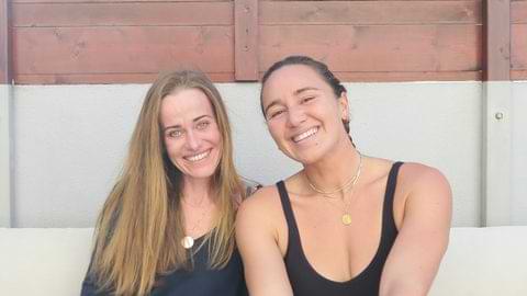Carissa Moore at Surf Atlantic Baleal World Champion surfer Carissa Moore smiling with host on the patio at Surf Atlantic in Baleal.