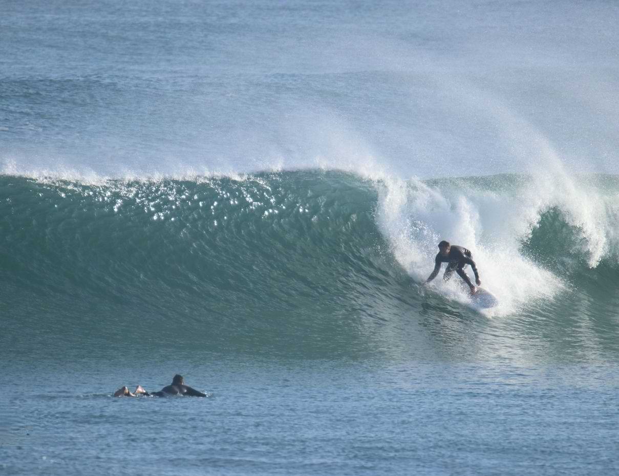Peniche Surf Guide Silver Coast Waves Surfer riding a powerful walling wave on Peniche's Silver Coast in Portugal.