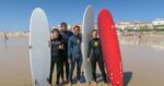 surfers with boards on beach