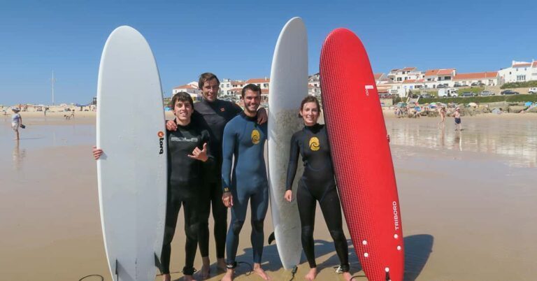 surfers with boards on beach