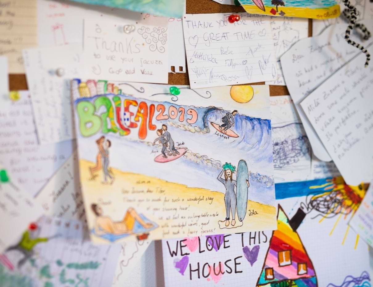 reviews Colourful handwritten notes and drawings pinned to board